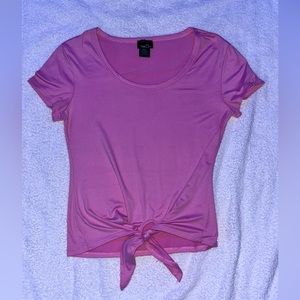 Silky lightly pink shirt with tie at the bottom.